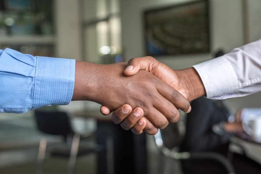 Handshake sealing a moving insurance agreement