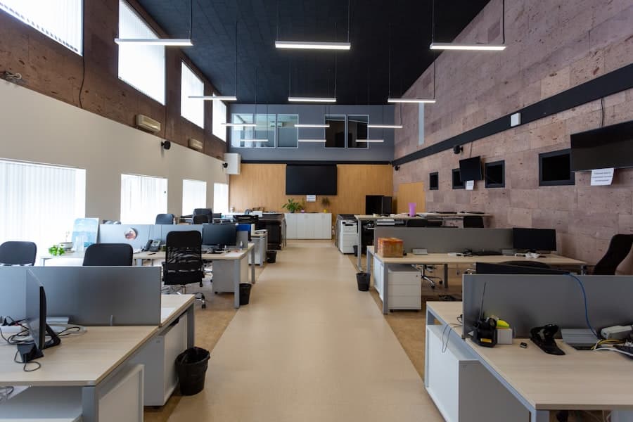 Modern open-plan office with rows of desks and computers